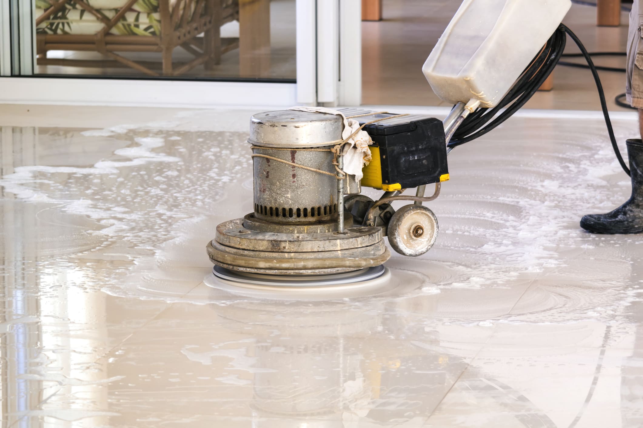 Photo of a man washing the floor with a cleaning machine